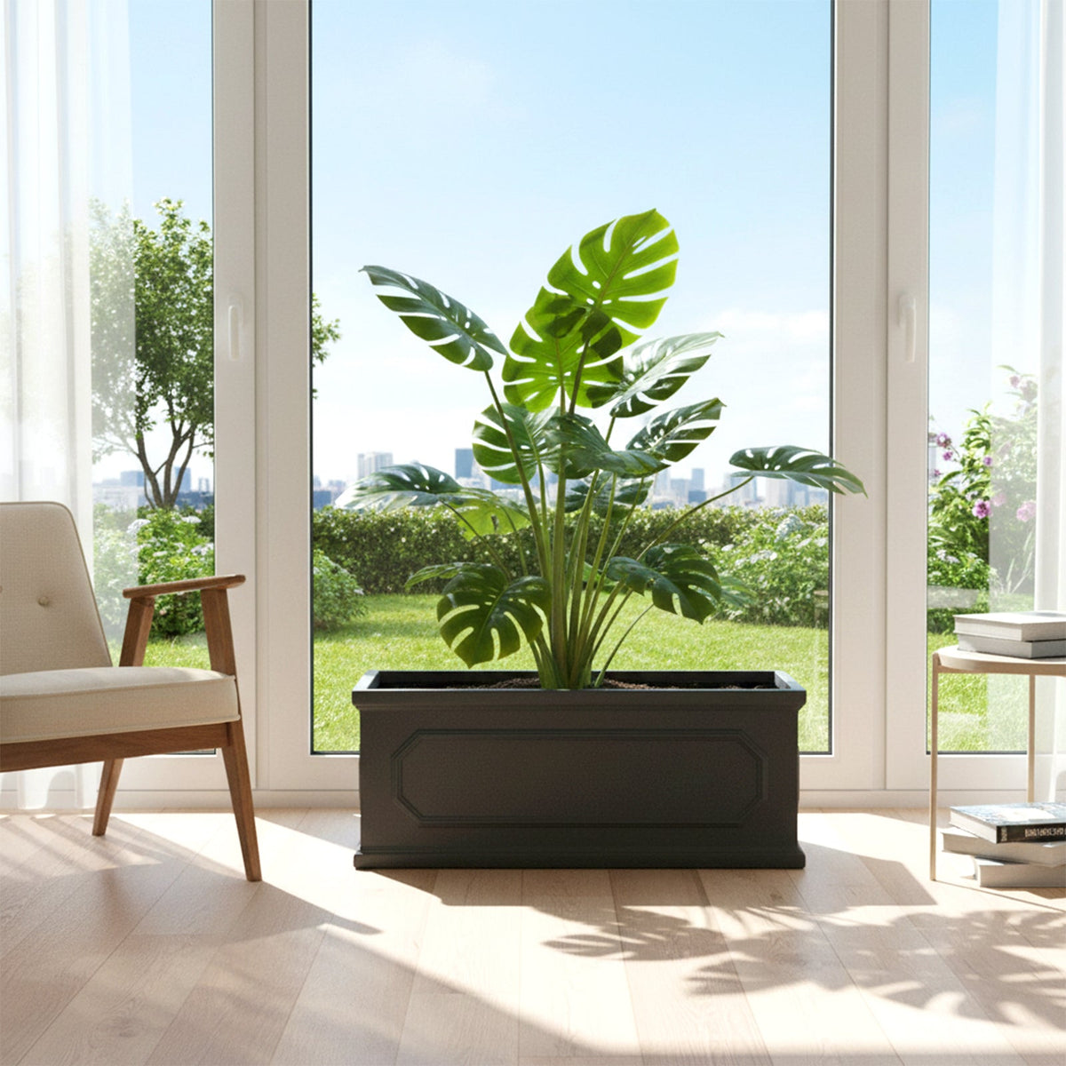 Black panelled planter with a monstera plant in a bright room by a window