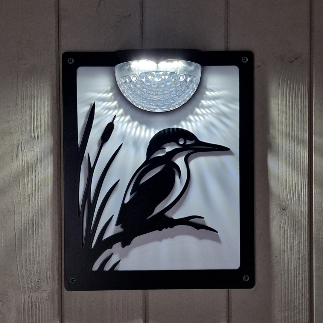 Kingfisher solar plaque with white backing panel lit at night