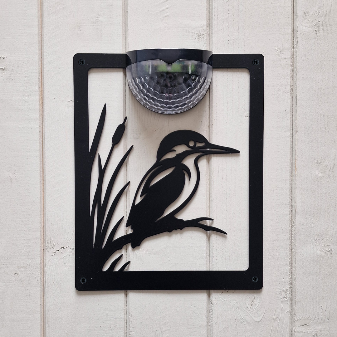 Open kingfisher and reeds cut-out solar plaque on white painted cladding