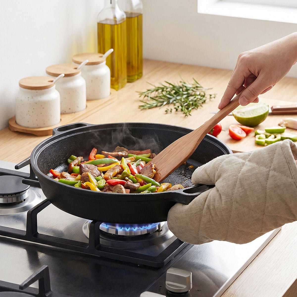 Stir-fried beef and peppers in the deep skillet on a gas hob, held with an oven glove