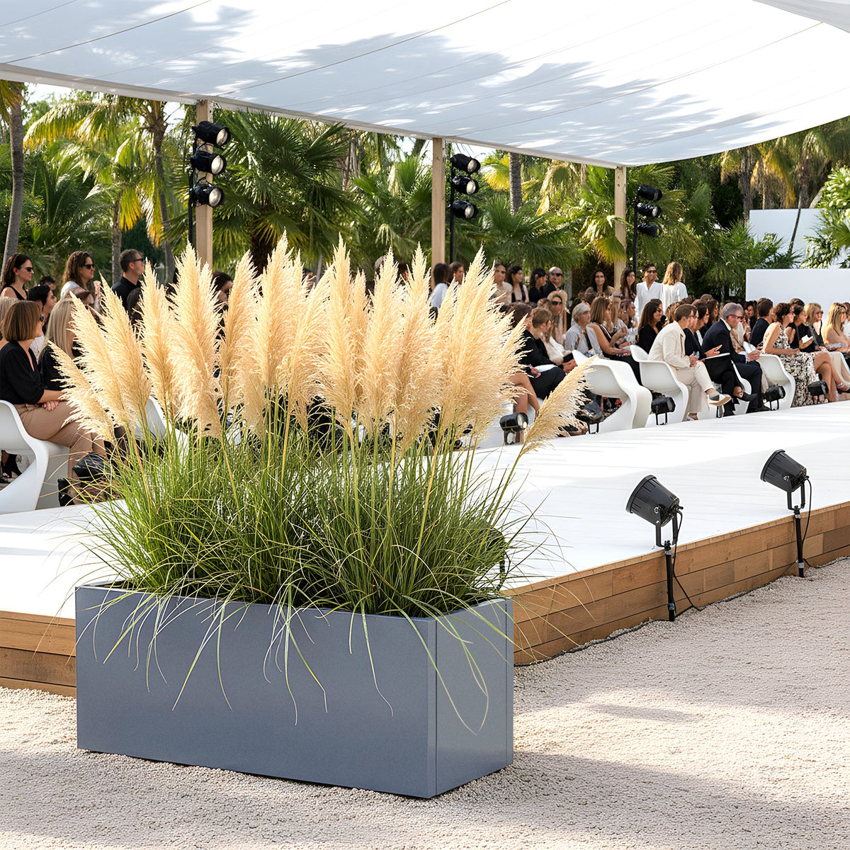 Grey metal planter with pampas grass beside an outdoor catwalk