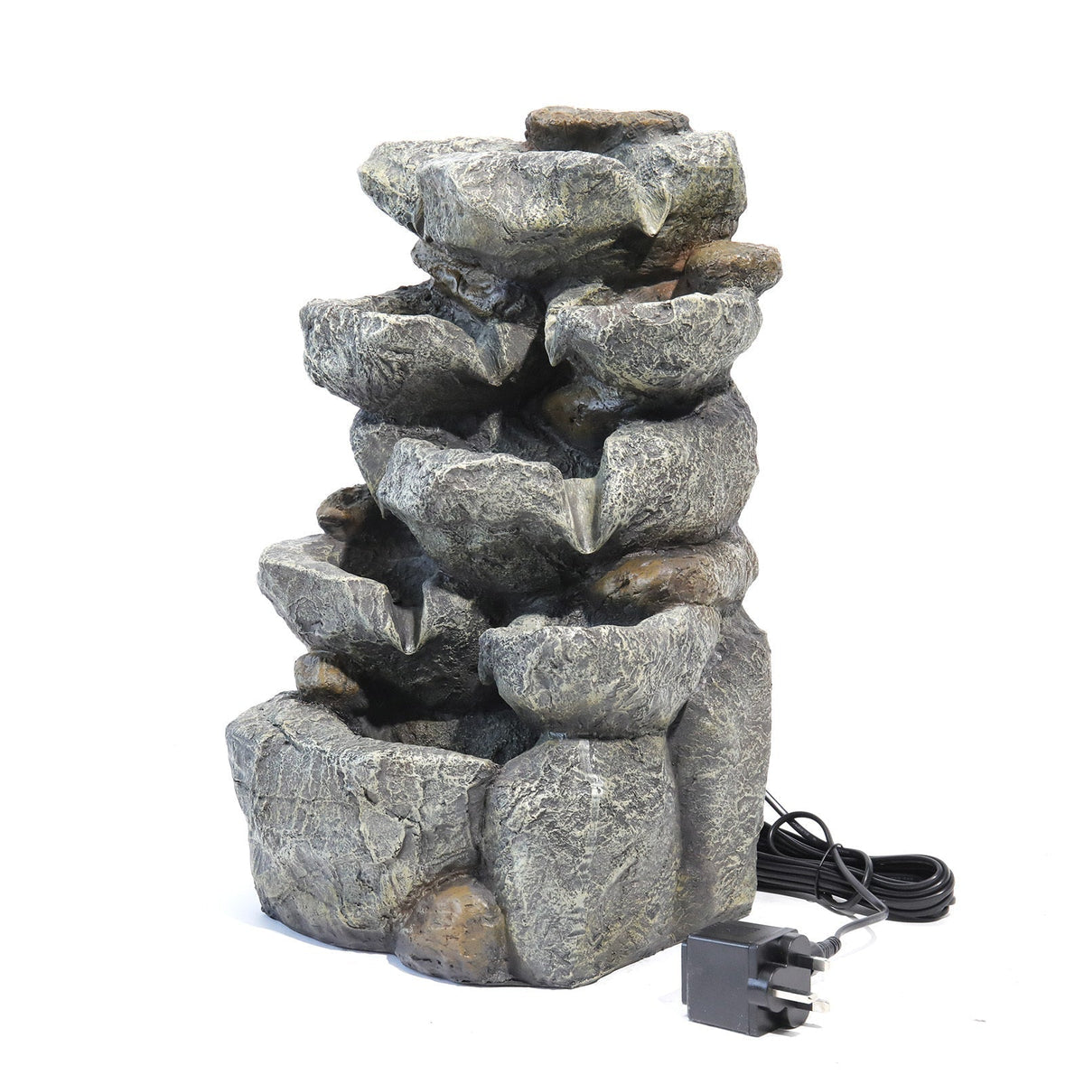 Three-quarter view of the rock cascade fountain on white with its cable and adapter