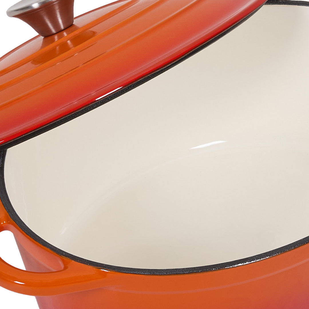 Close-up of the cream enamel interior under the tilted orange lid