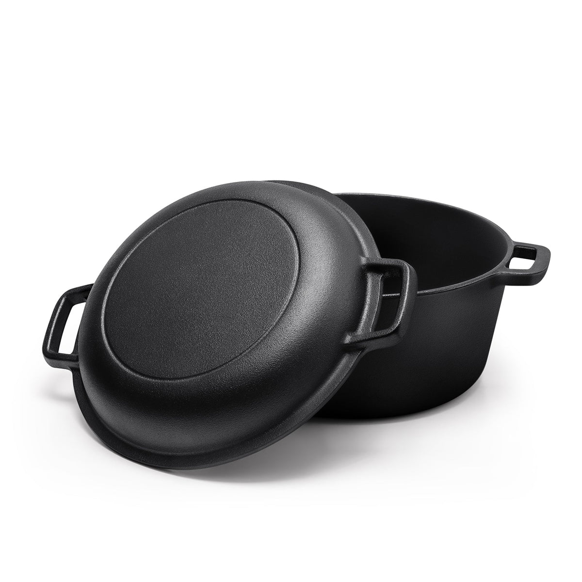 Cast iron lid-pan tilted against the open pot, showing the loop handles on both