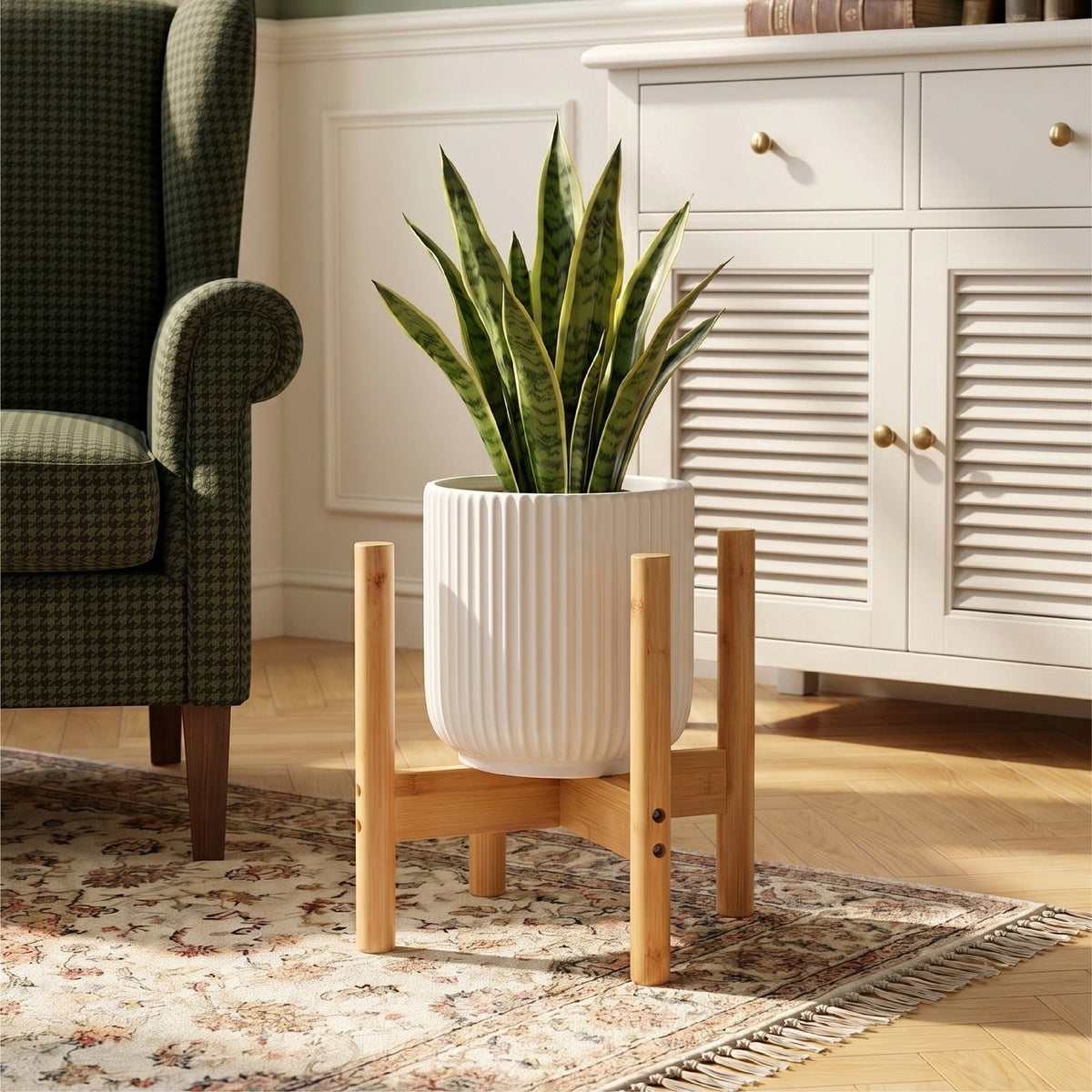 Bamboo plant stand holding a ribbed white pot with a snake plant on a rug