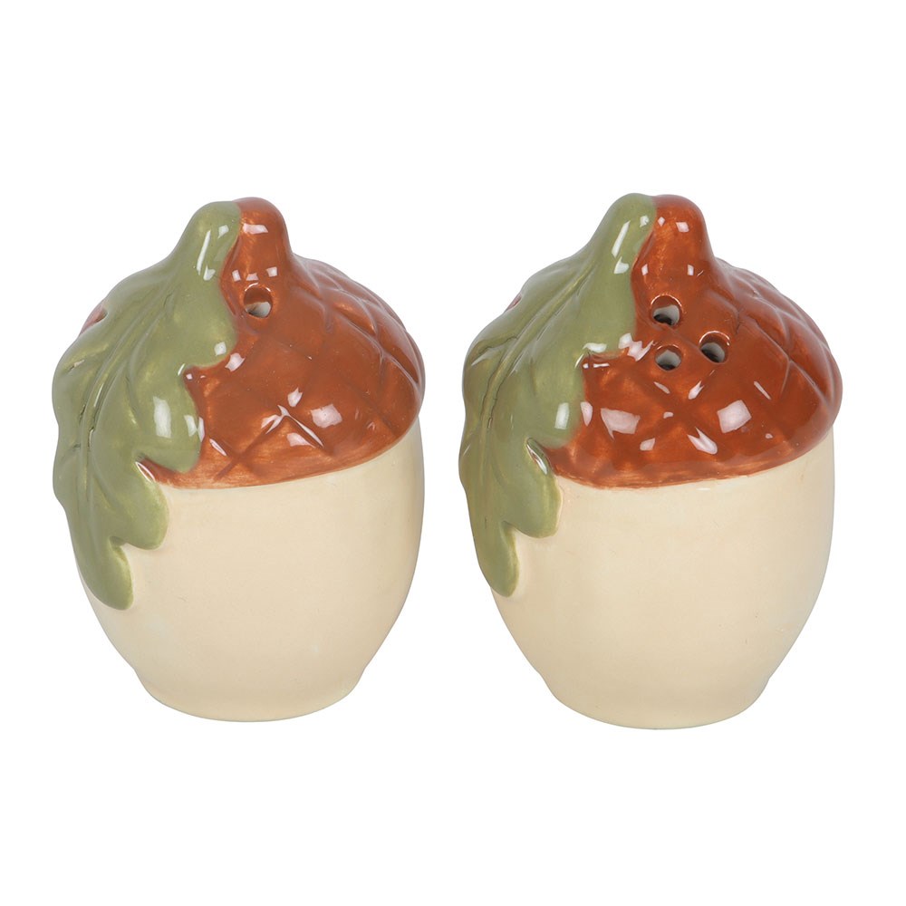 Ceramic acorn salt and pepper shakers on white, one with a single hole and one with three holes in the cap