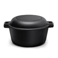 Black cast iron double Dutch oven with its pan-shaped lid on, on white