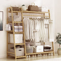 Natural bamboo clothes rack with shirts on the rail, folded clothes on the side shelves and shoes below