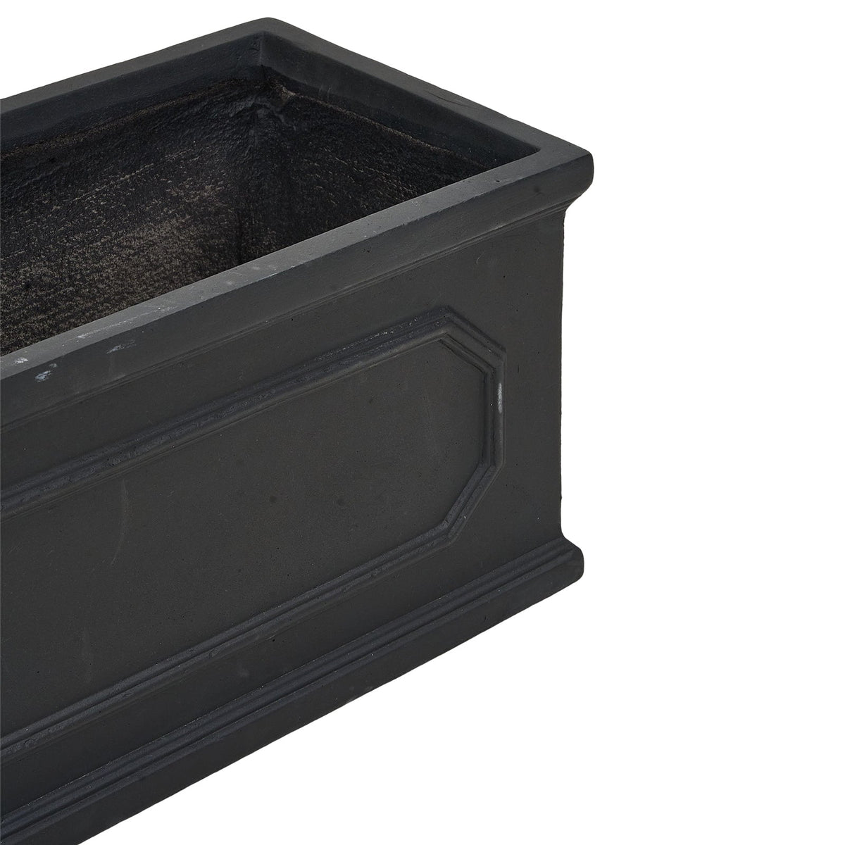 Close-up of a corner of the black trough with its raised panels and rim