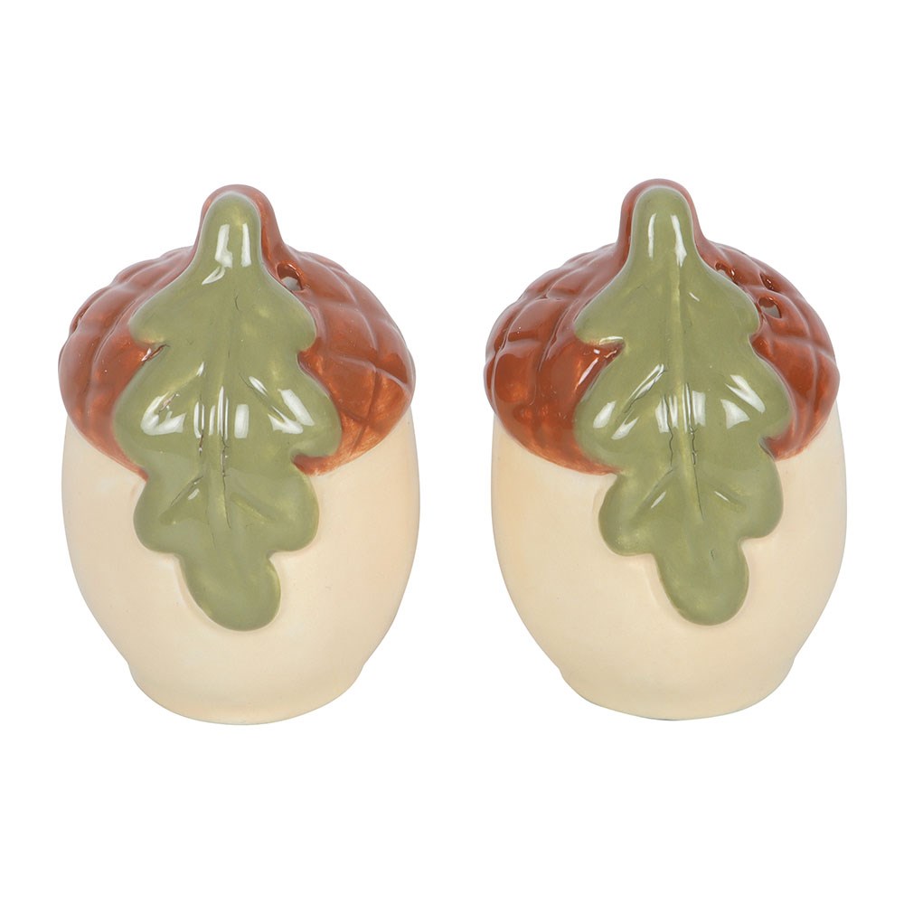 Ceramic acorn shakers on white, turned to show the green oak leaf on the front of each