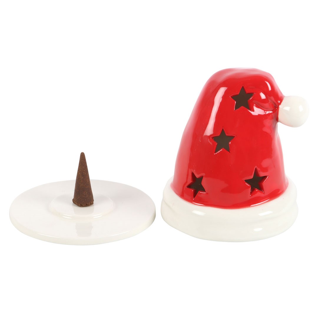 Santa hat holder lifted off its round white base plate with an incense cone on the plate, on white