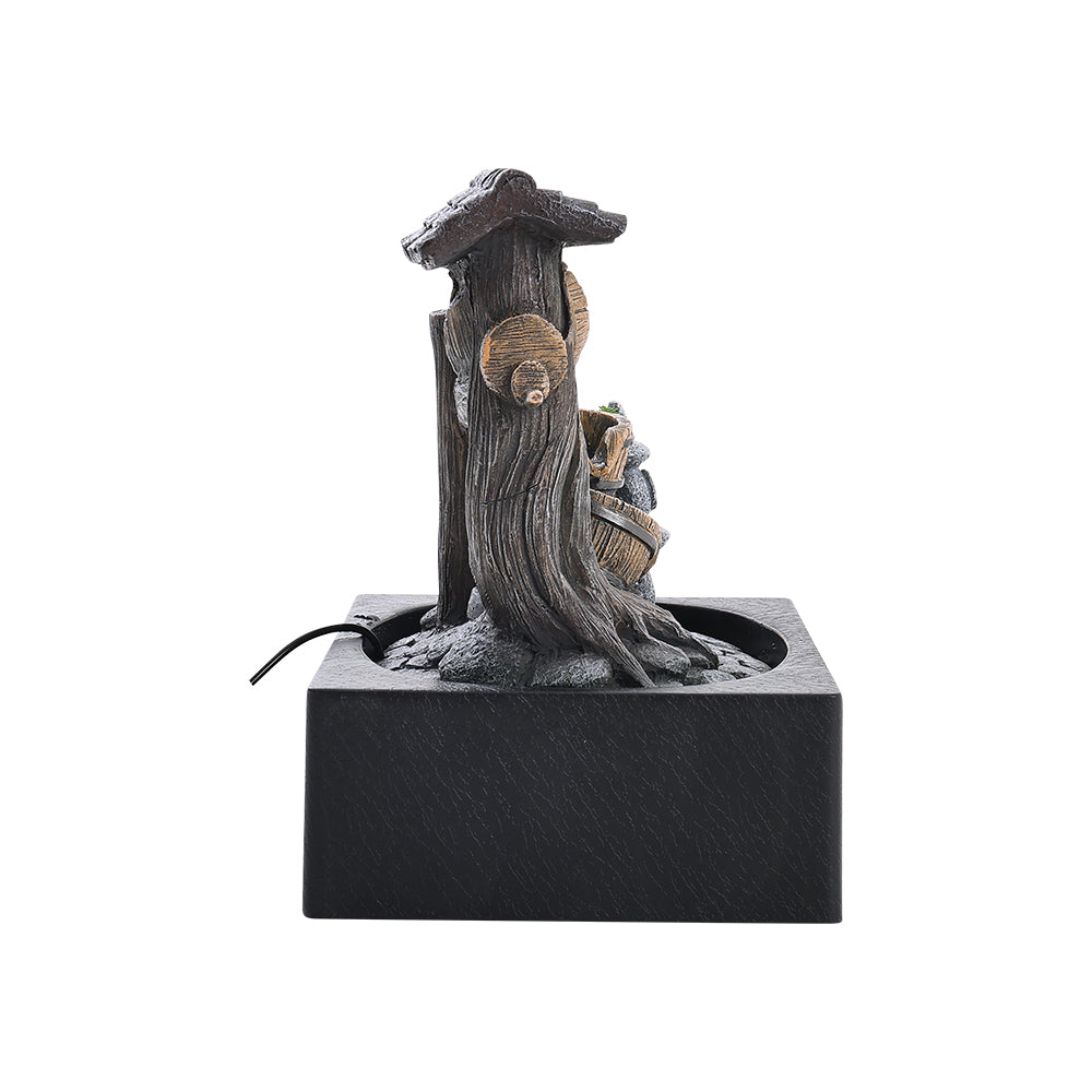 Back of the tabletop fountain showing the tree trunk and the pump cable