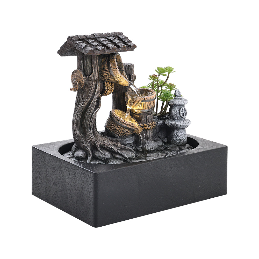 Three-quarter view of the tabletop fountain and its rectangular dark basin on white