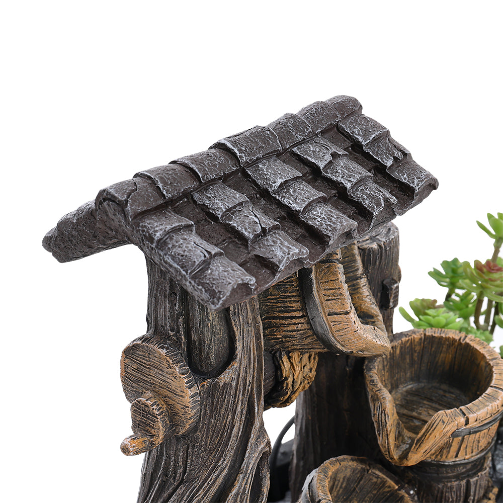 Close-up of the tiled resin roof and wooden-look spout of the fountain
