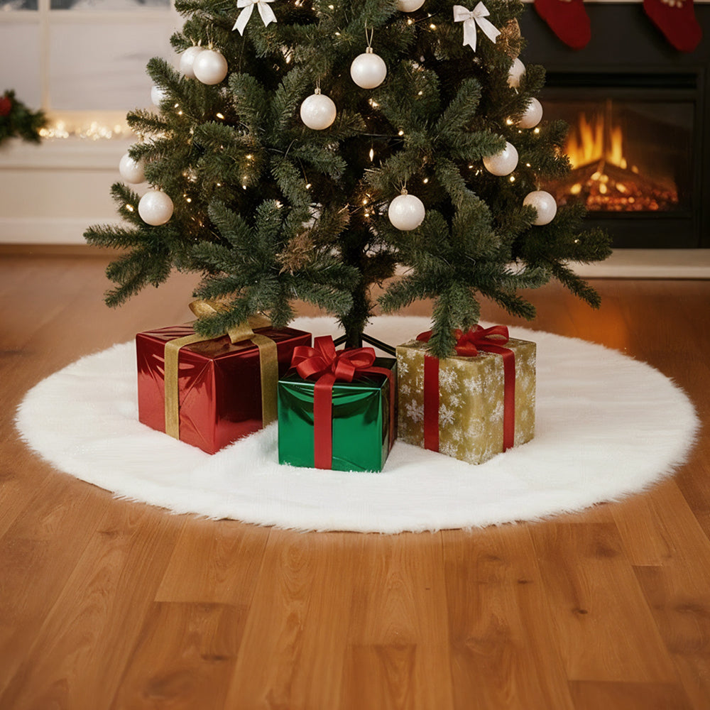 White plush tree skirt with presents under a Christmas tree beside a fireplace