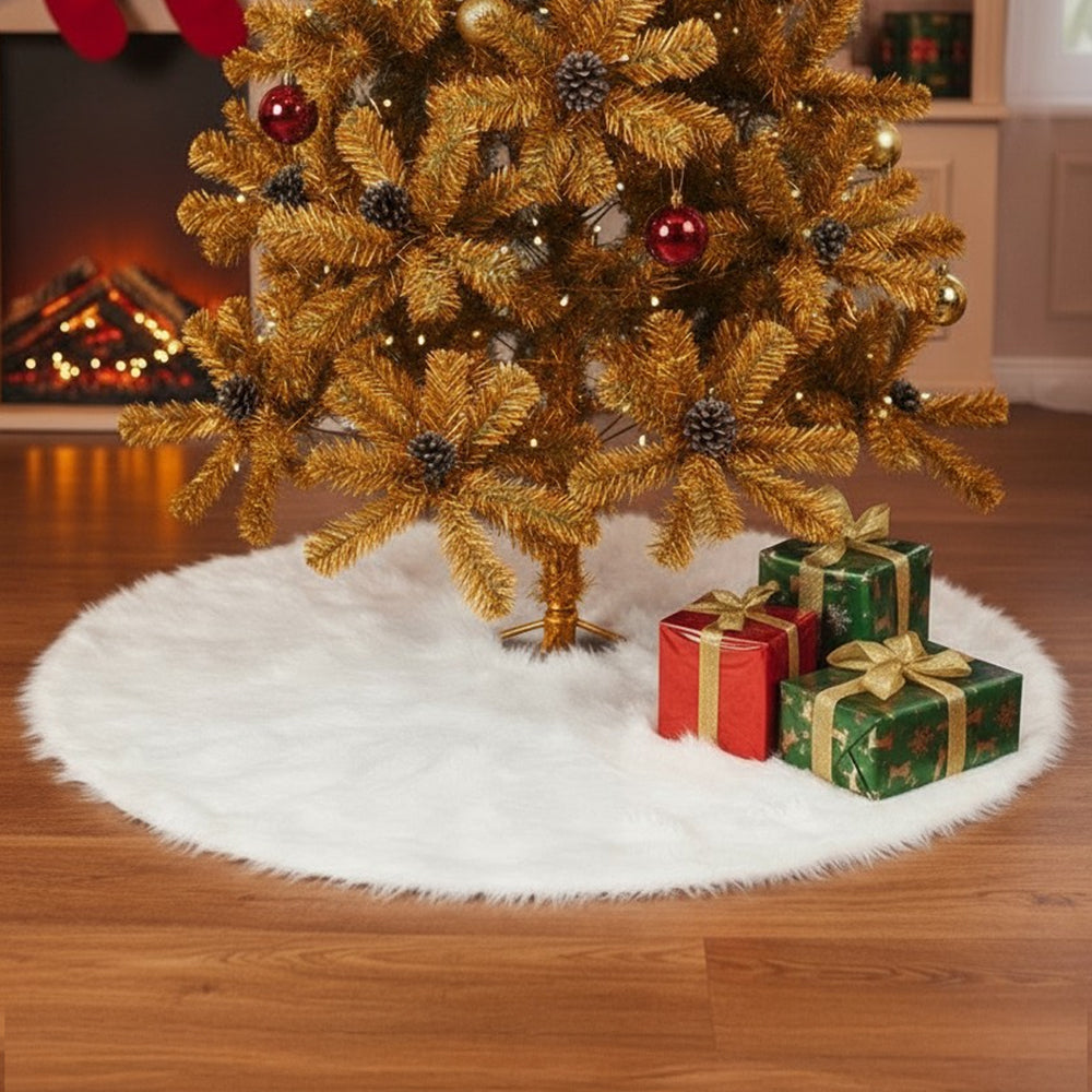 White plush tree skirt under a gold Christmas tree with wrapped presents