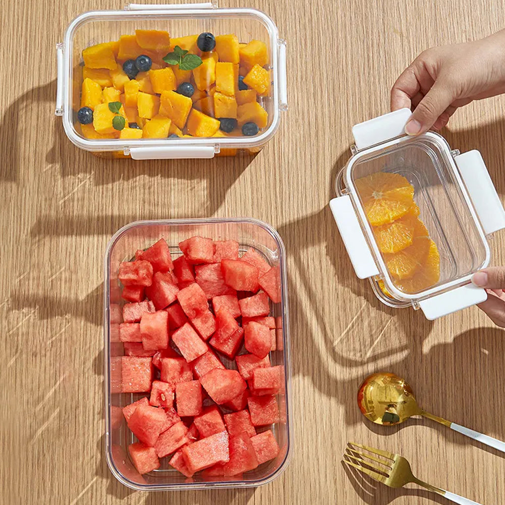 Top view of the clear boxes filled with mango and watermelon on a wooden table, a hand opening a lid