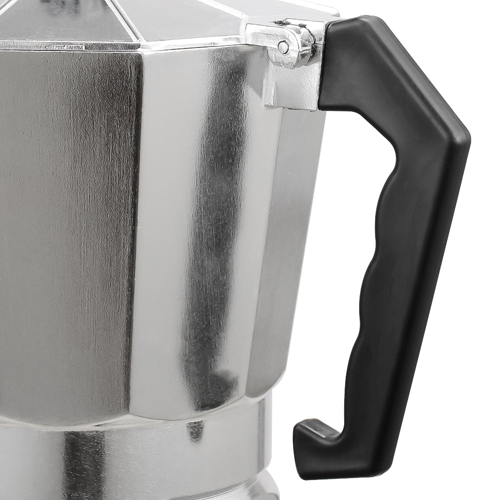 Close-up of the black angular handle and hinge on the aluminium moka pot