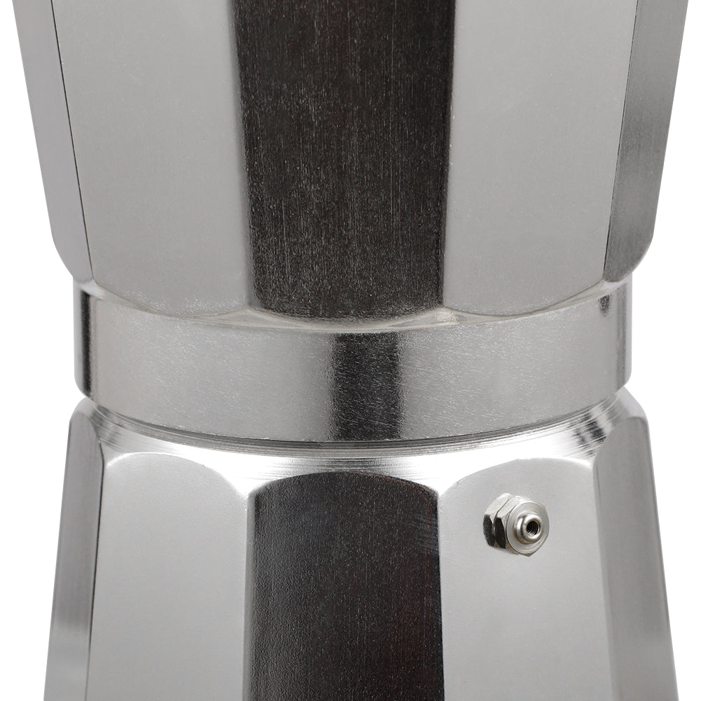 Close-up of the brass safety valve on the faceted base of the moka pot