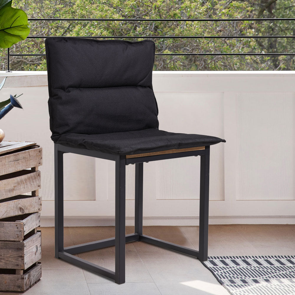Black one-piece seat and back cushion on a metal chair on a balcony