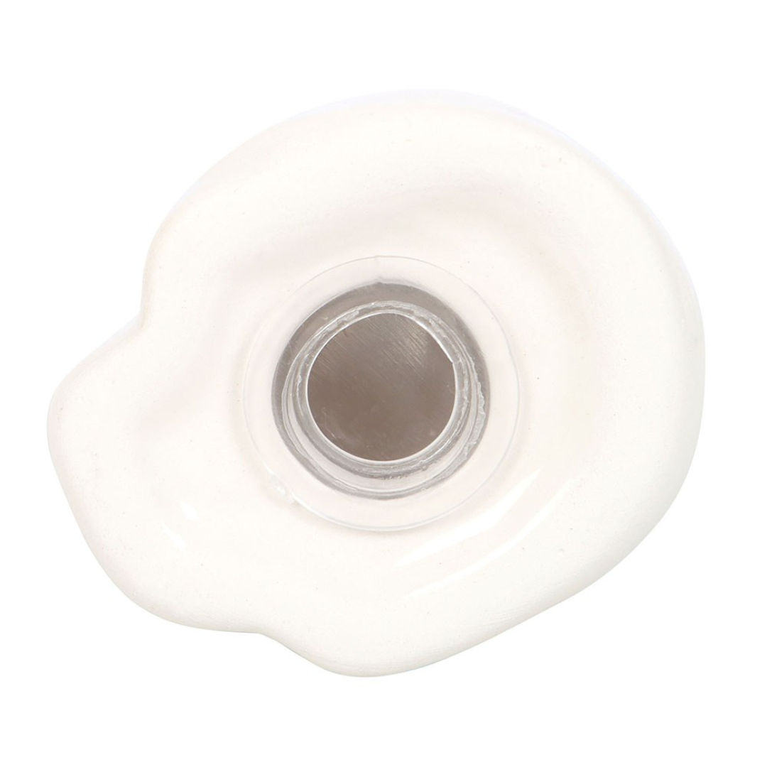 Underside of a cat shaker showing the round filling opening with its stopper
