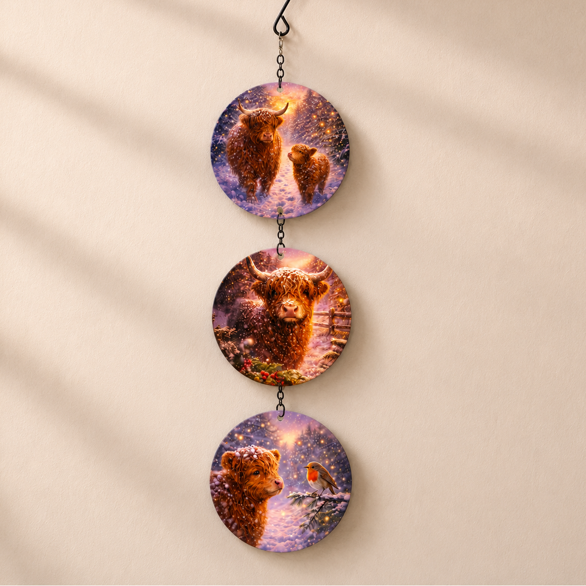 The Highland Cow glass suncatcher hanging on a warm beige wall in soft light