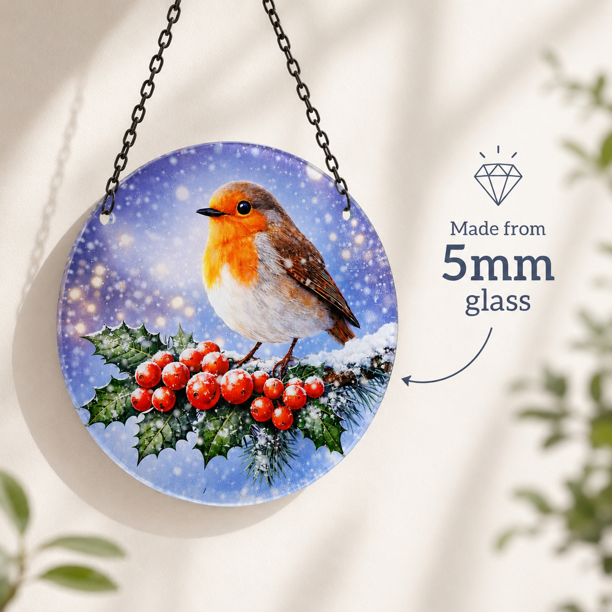 Glass robin suncatcher hanging against a pale wall, with a note that it is made from 5 mm glass