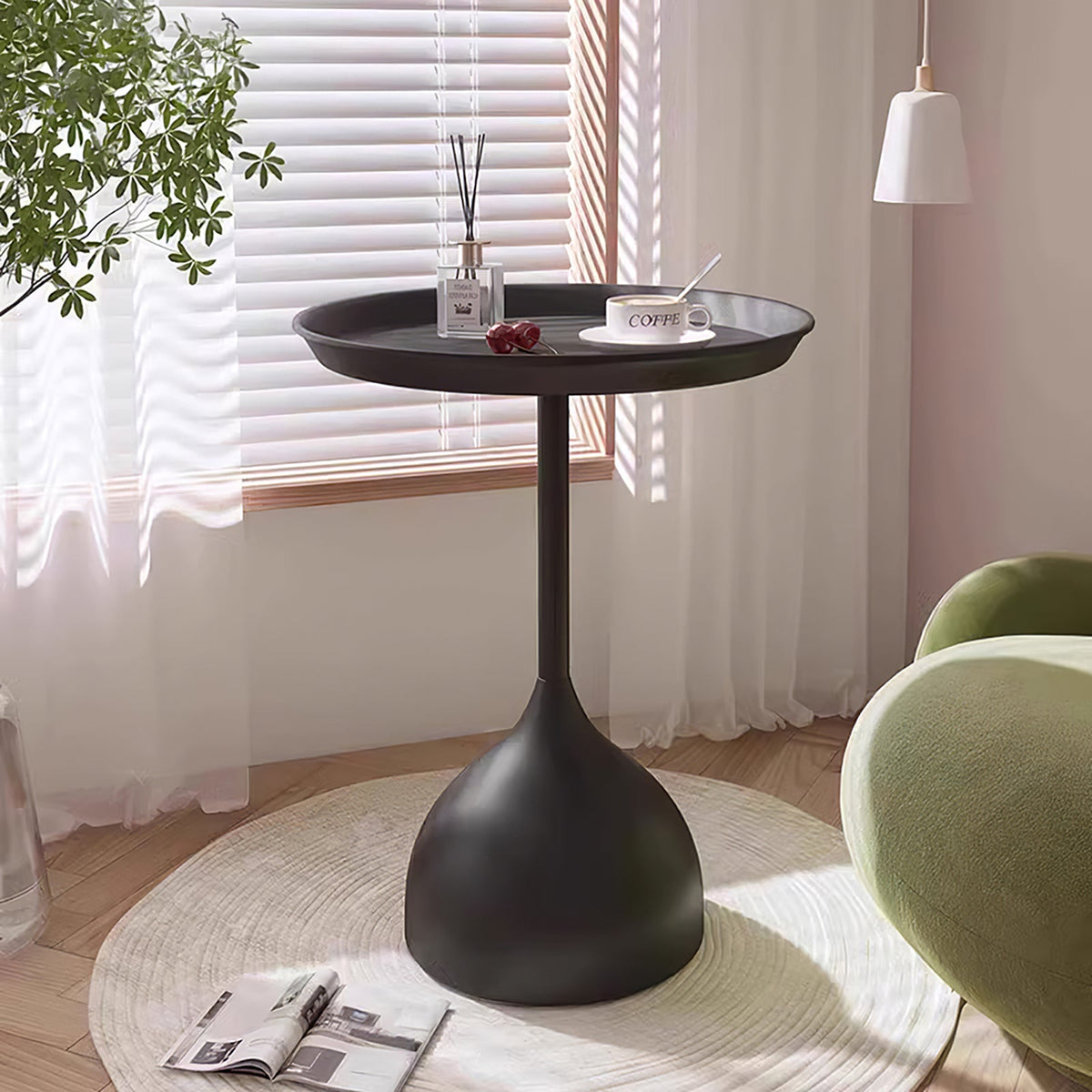 Black round side table beside a chair on a round rug