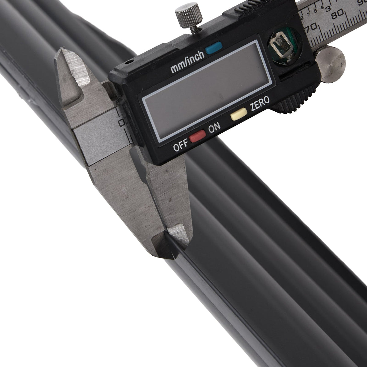 Digital caliper measuring the edge of the dark grey steel panel