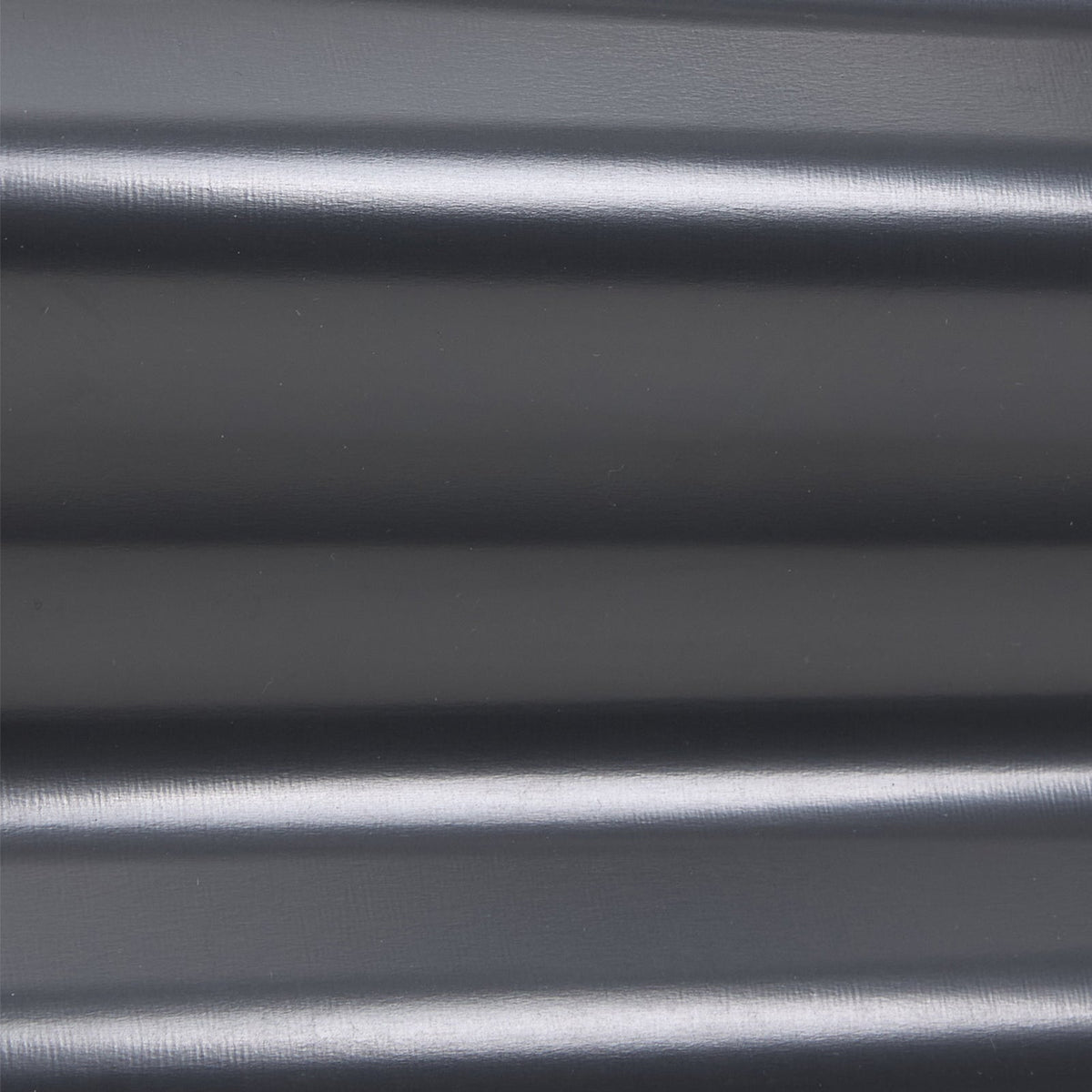 Close-up of the smooth dark grey coating on the corrugated panel