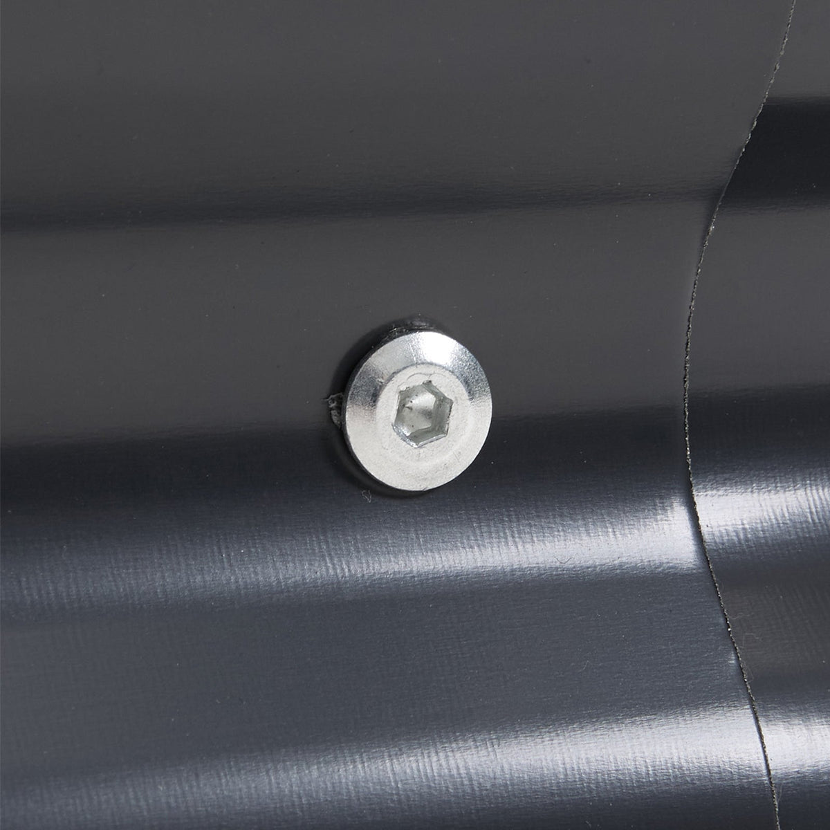 Close-up of a silver hex bolt joining a panel to a corner post