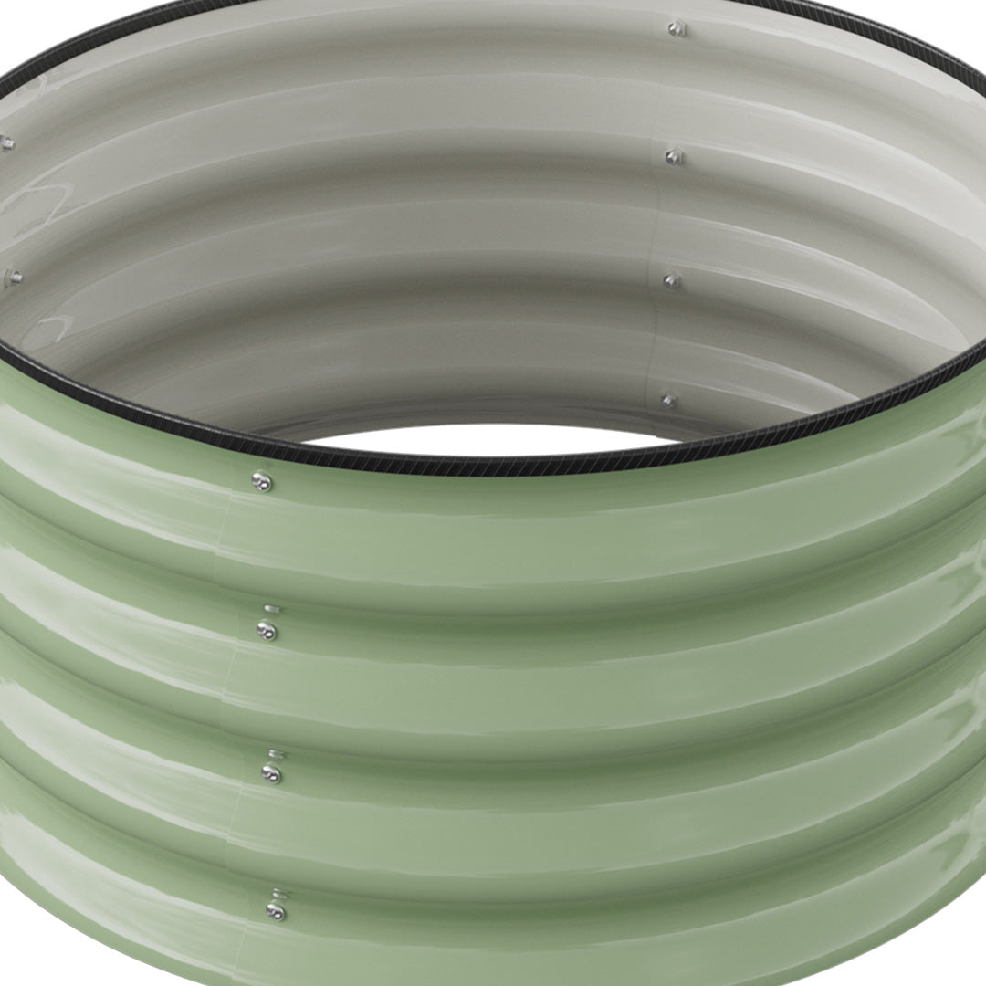 Inside of the empty round raised bed showing its open bottom and pale grey inner wall