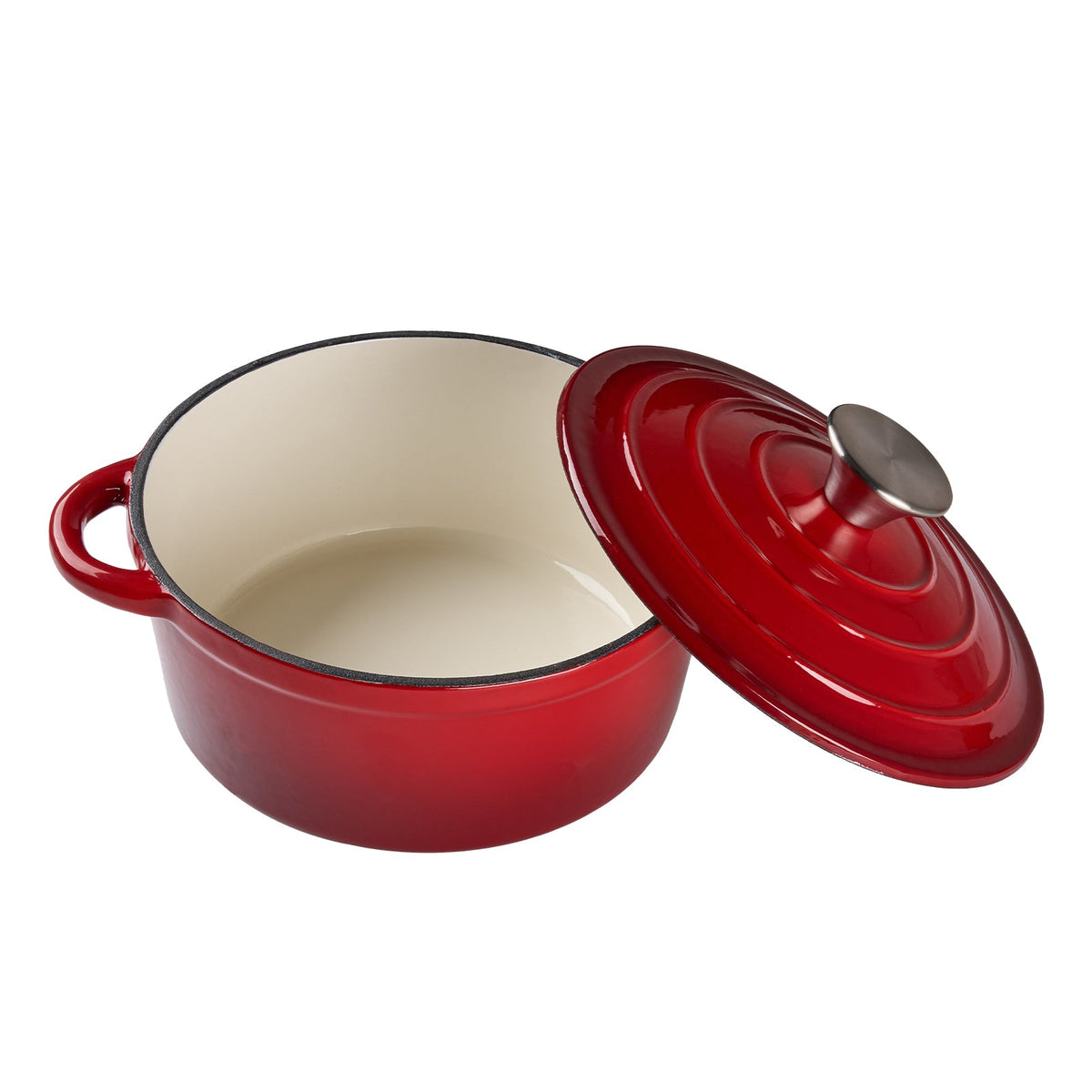 Red enamelled Dutch oven on white with its lid tilted open, showing the cream enamel inside