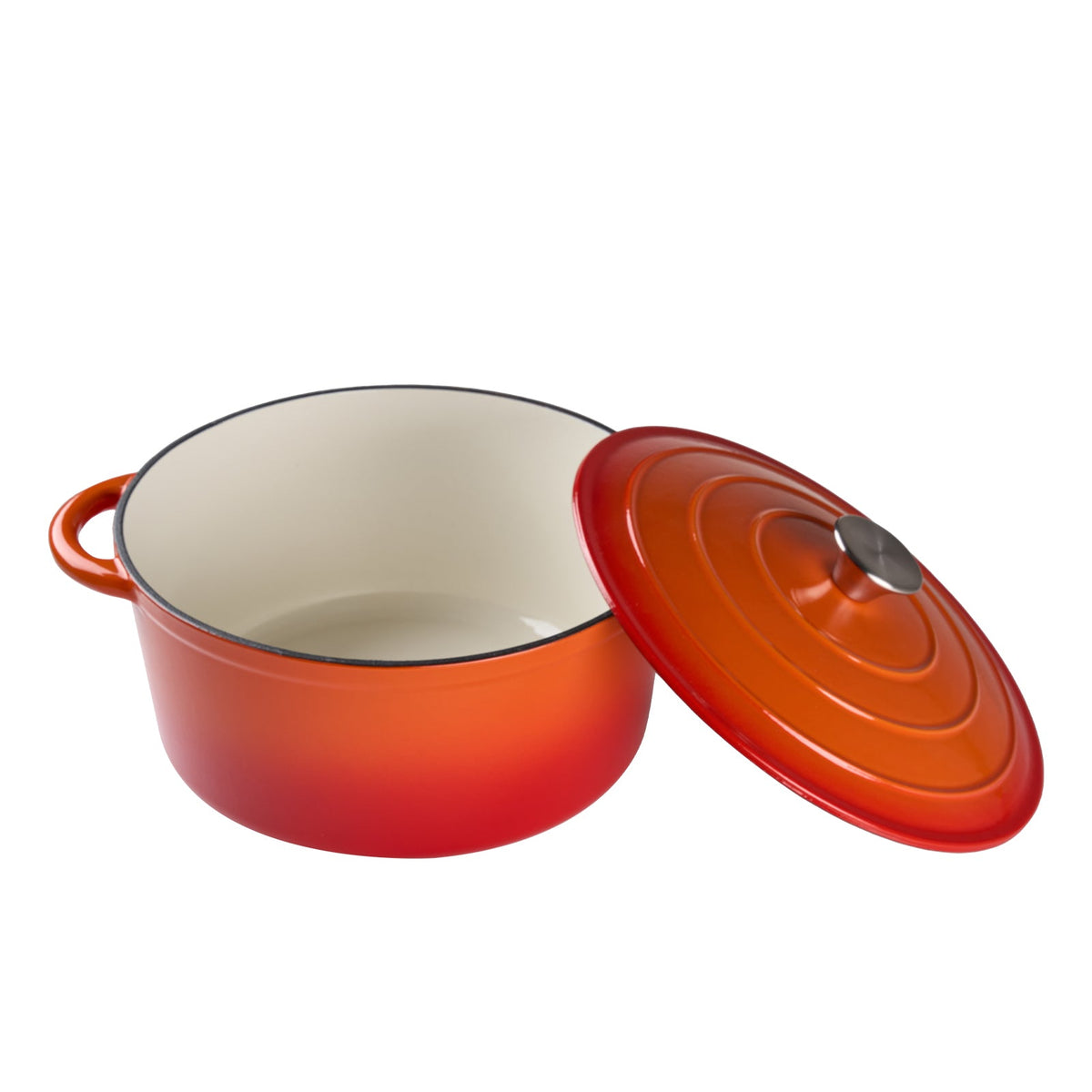 Orange enamelled Dutch oven on white with its lid tilted open, showing the cream enamel inside