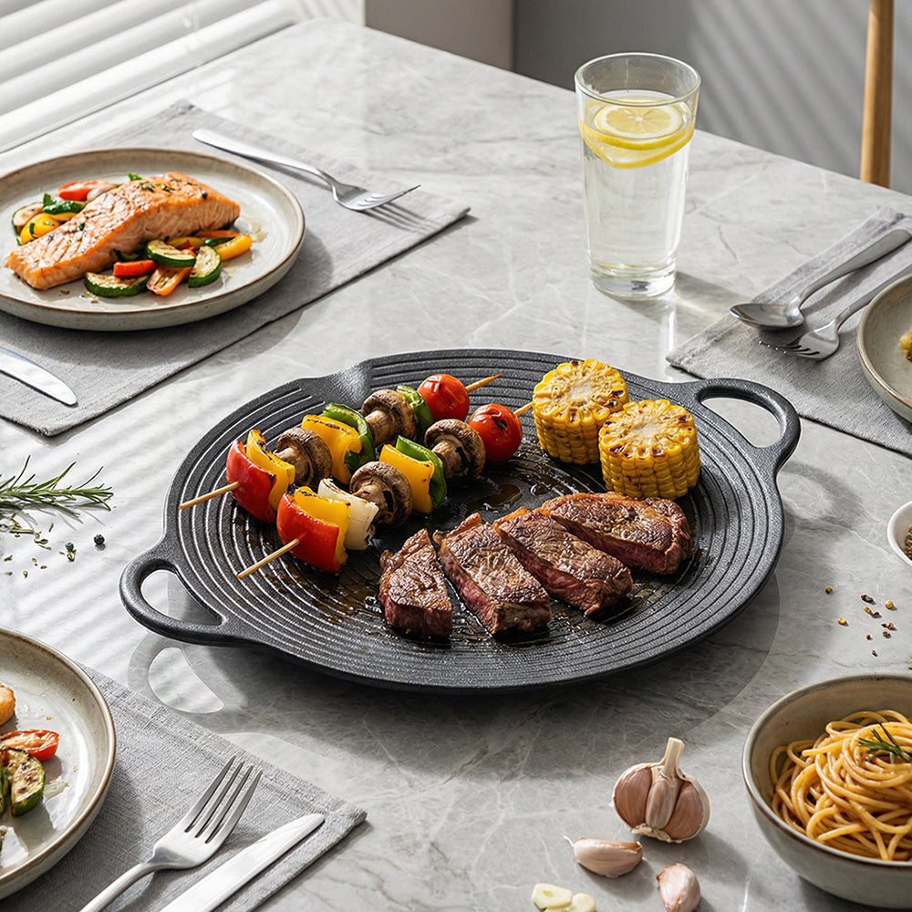 Steak, vegetable skewers and corn on the ringed cast iron grill pan on a marble table