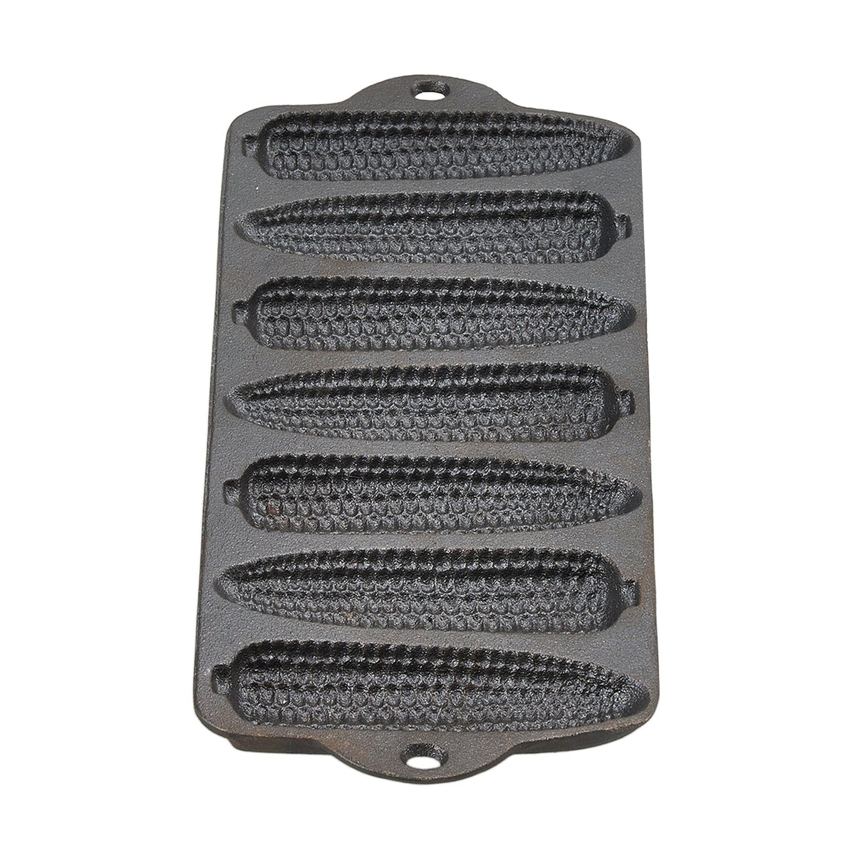 Empty cast iron cornbread pan with seven corn cob moulds and two end handles on white