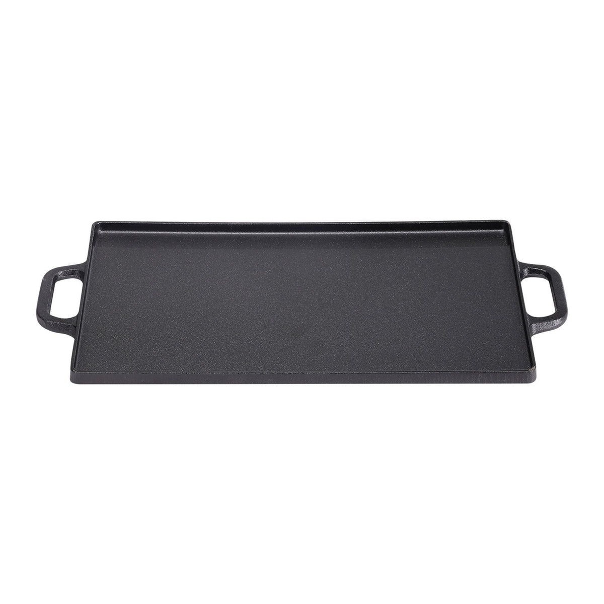 Flat side of the black cast iron griddle with its two loop handles on white