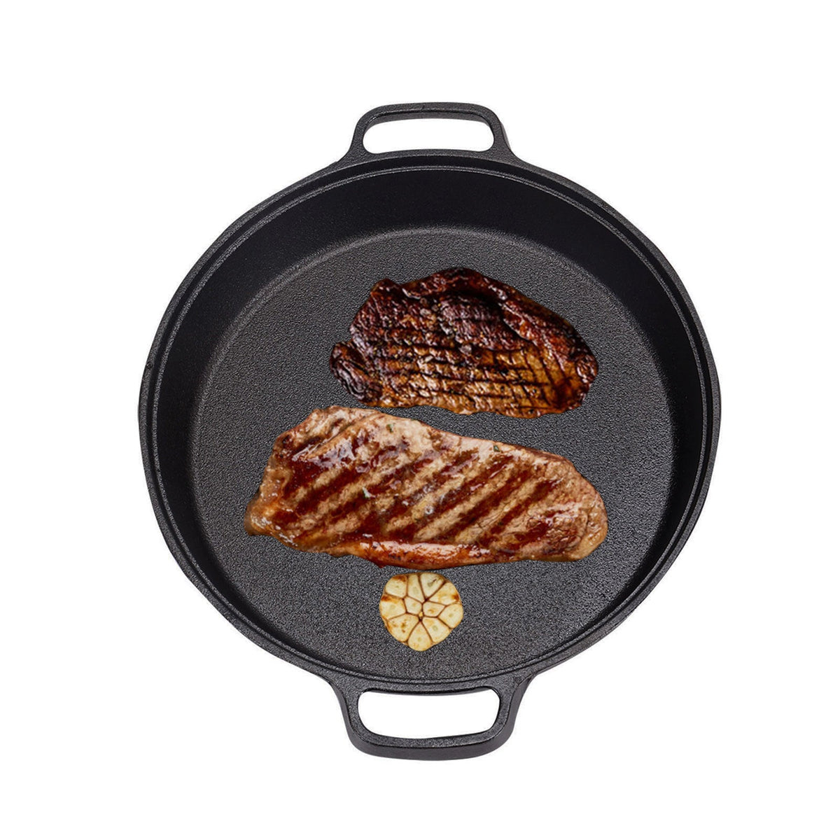 Top view of the cast iron skillet with two grilled steaks and garlic on white