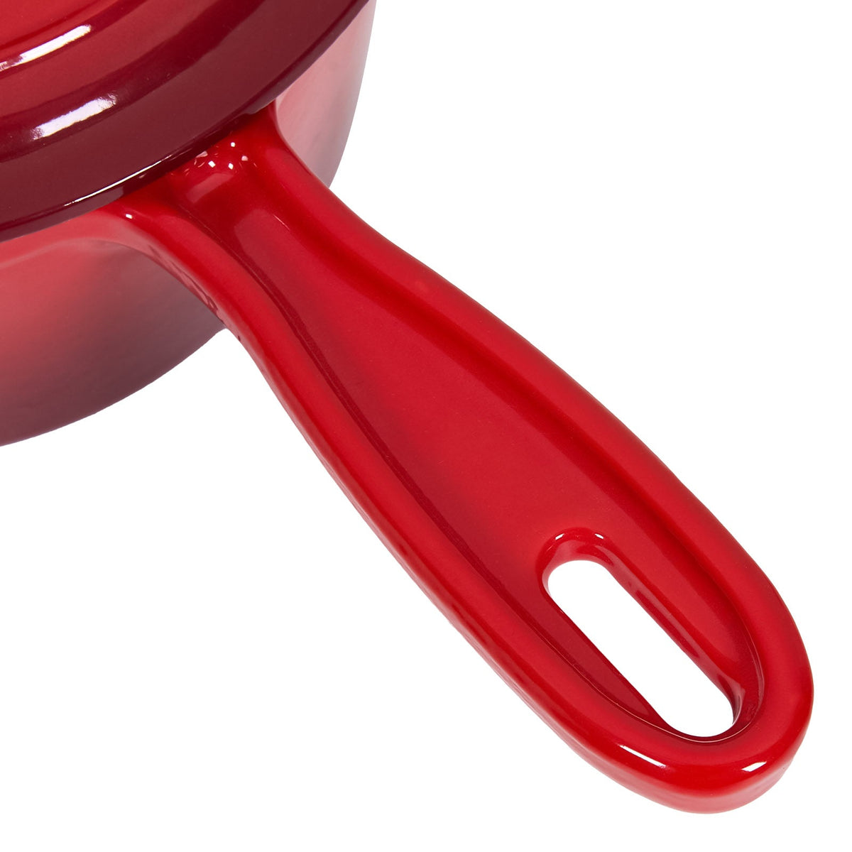 Close-up of the saucepan's long red enamelled handle with an oval hole at the end