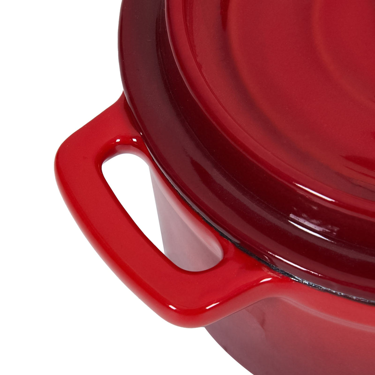 Close-up of a red enamelled loop handle and the lid edge
