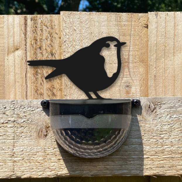 Robin solar wall light on a wooden fence panel