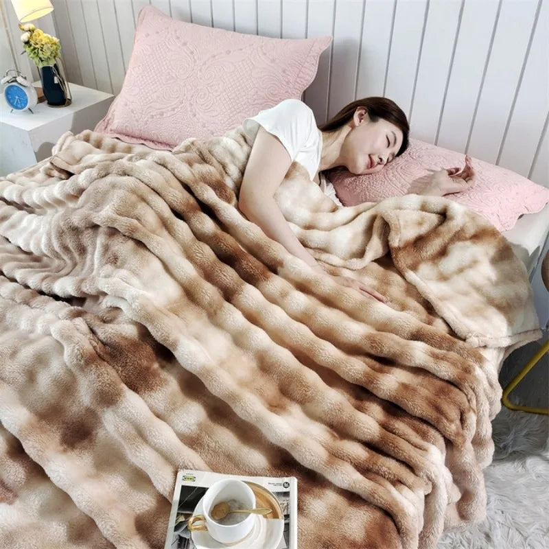A woman under the striped plush blanket in bed with a breakfast tray