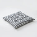 Light grey and white gingham tufted seat cushion on a white background