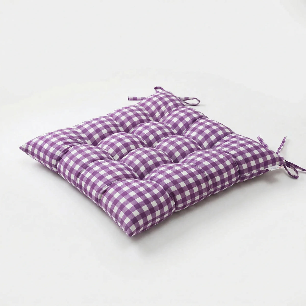 Purple and white gingham tufted seat cushion with ties at two corners