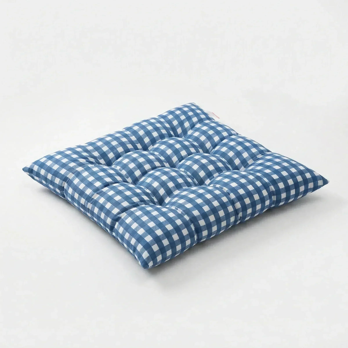 Blue and white gingham tufted square seat cushion on a white background
