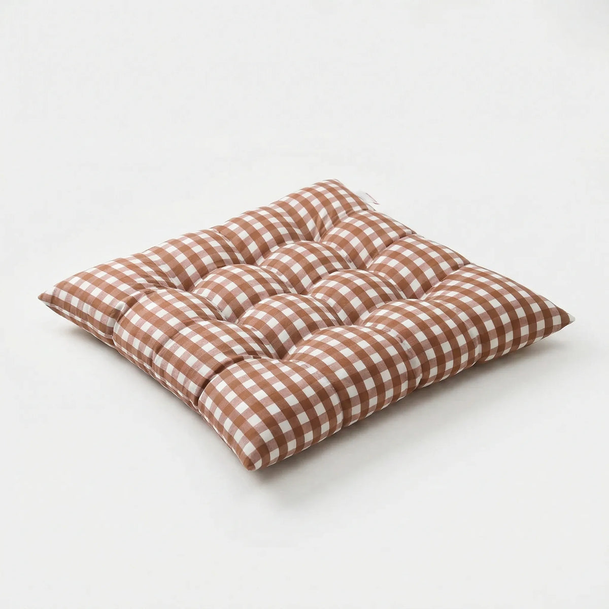 Brown and white gingham tufted square seat cushion on a white background