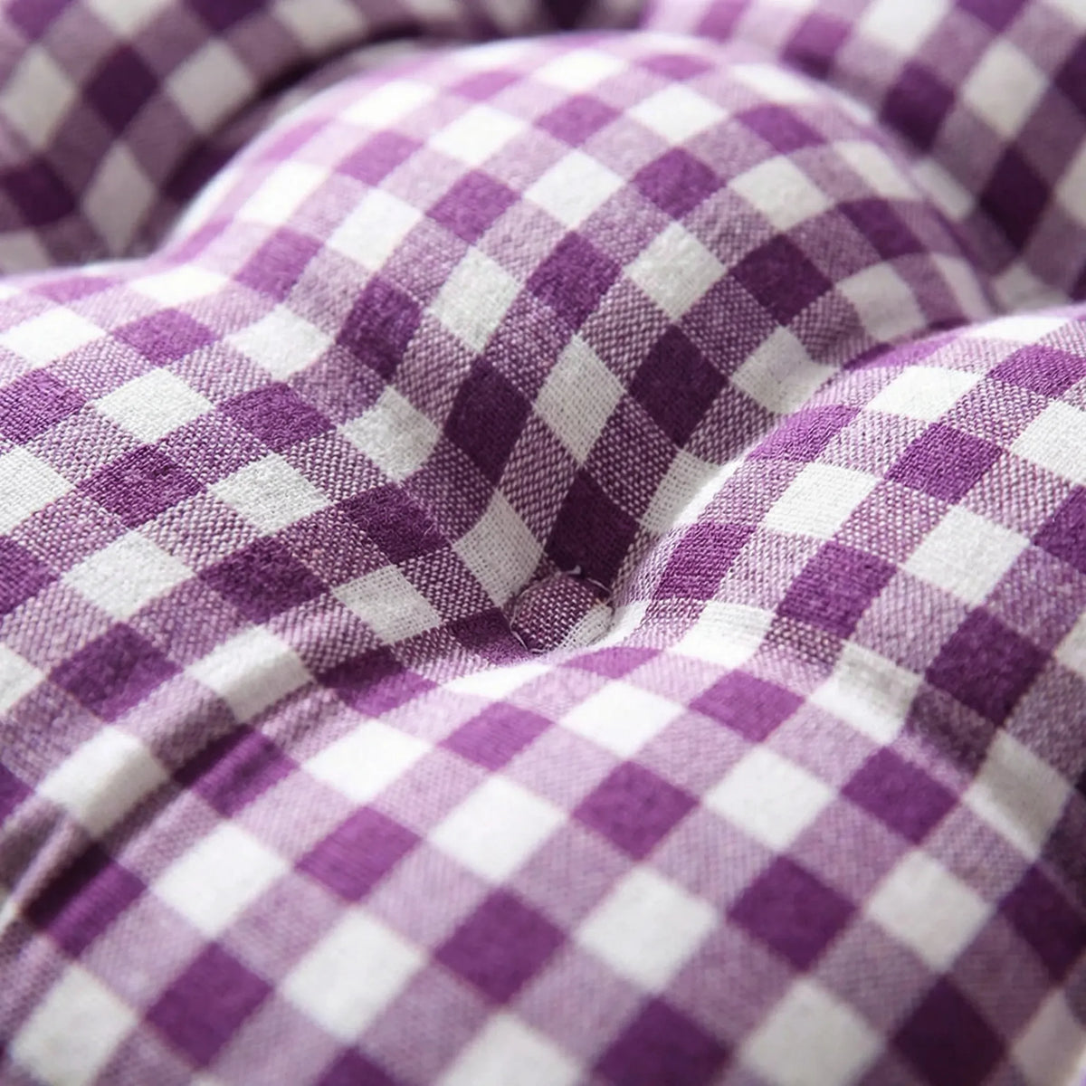 Close-up of the purple gingham fabric gathered at a tuft