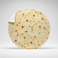 Round beige tortilla-print fleece blanket standing upright, one edge curled to show the plain white reverse