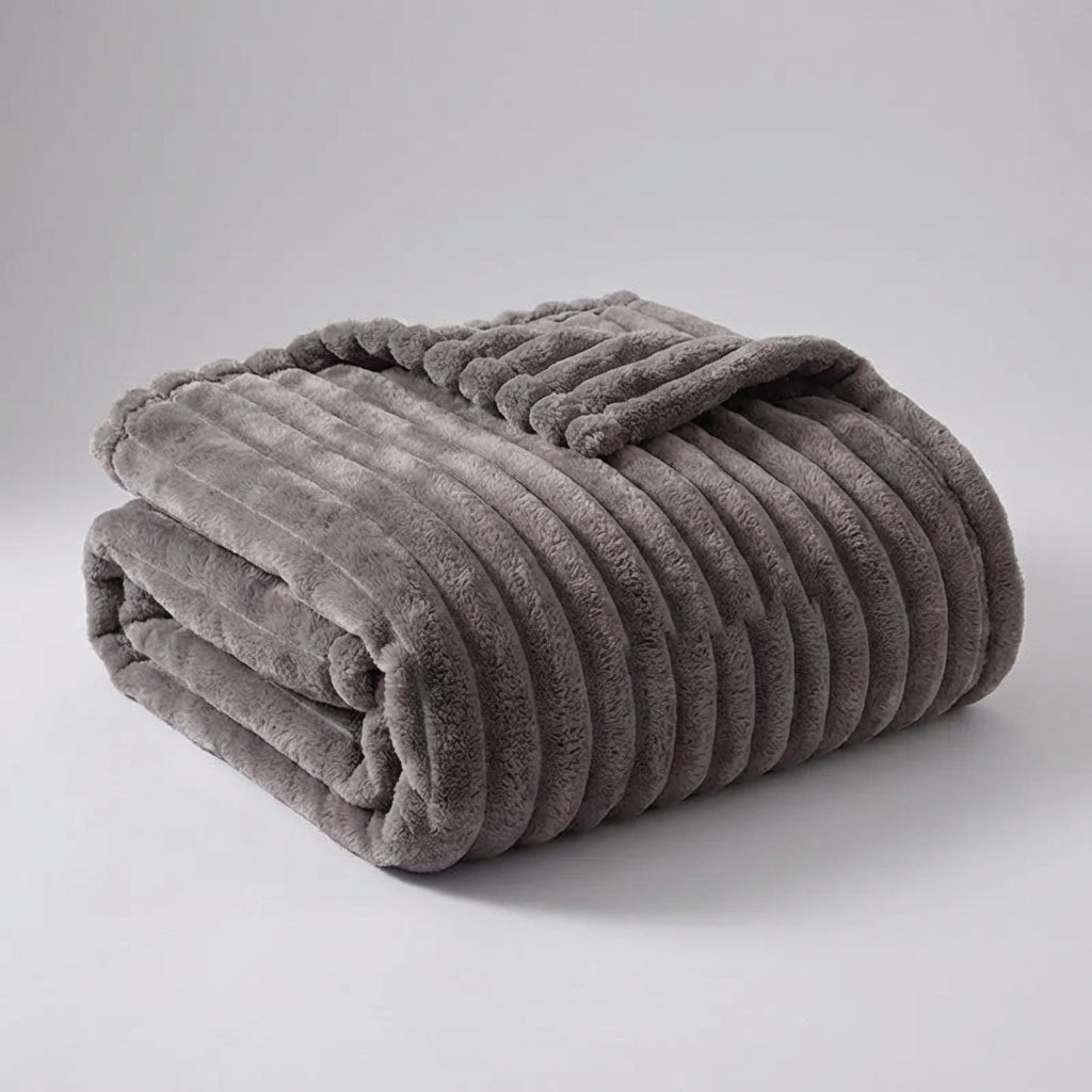 Taupe grey ribbed throw folded on a pale background