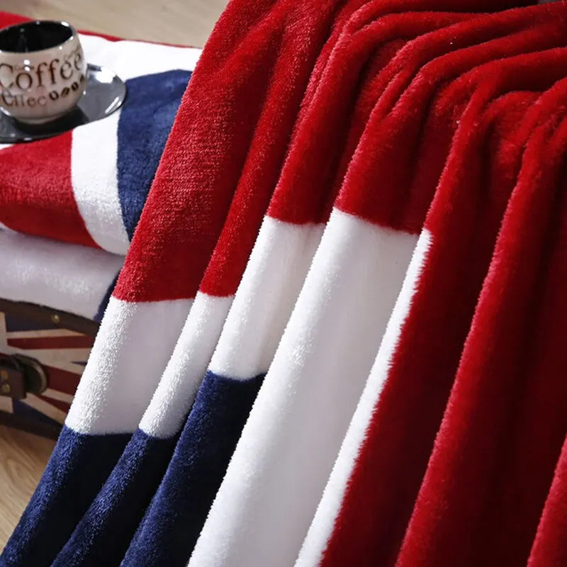 Draped folds of the Union Jack throw with a coffee cup on a table behind